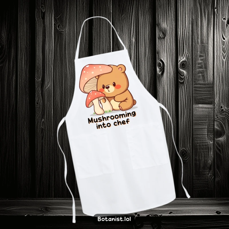 Funny bear with a surprised expression examining a giant mushroom, perfect for this whimsical and practical kitchen apron.