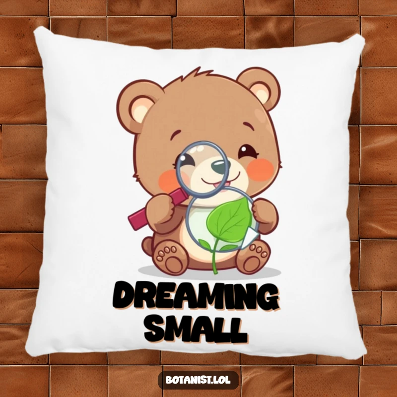 Cheerful, funny bear cub with a magnifying glass, examining a tiny, sentient leaf, offering plush comfort and curiosity on a pillow.