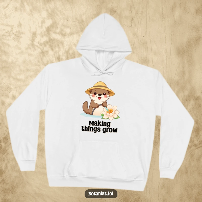 Funny hoodie depicting a content otter in a straw hat, watering an enormous flower, celebrating the joy of nature and gardening.