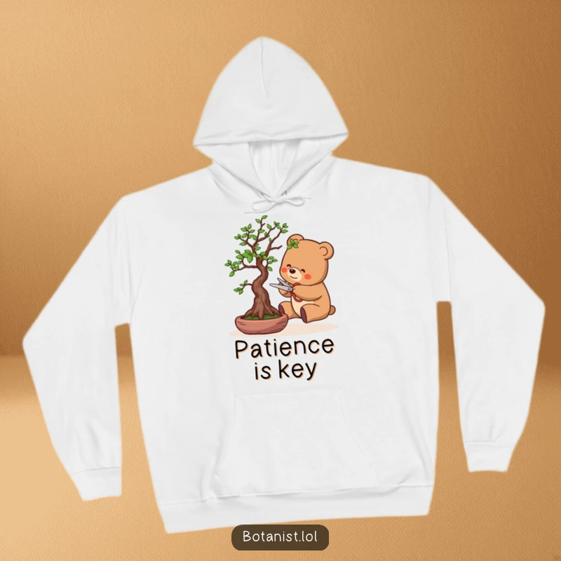 Funny hoodie showing a bear meticulously pruning a bonsai tree with tiny scissors, exuding a calm and focused demeanor. Perfect for cozy humor.