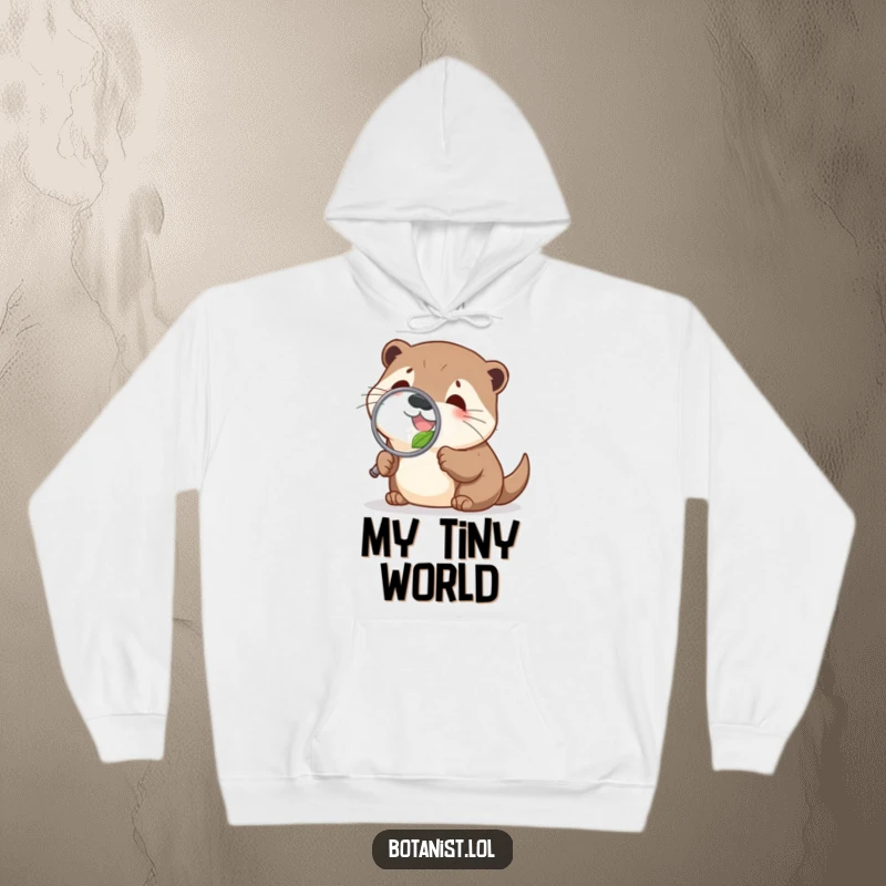 Funny delighted otter hoodie, investigating a leaf with a magnifying glass, offering cozy comfort and nature-themed humor.