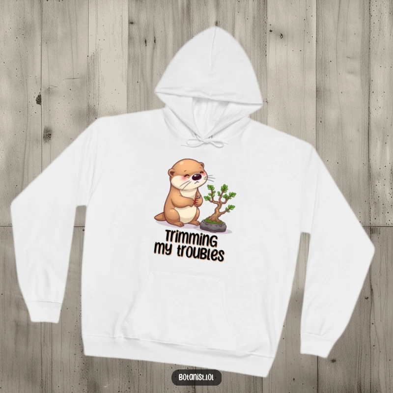 Funny otter bonsai hoodie, depicting a diligent otter meticulously pruning a bonsai tree, perfect for cozying up with humor.