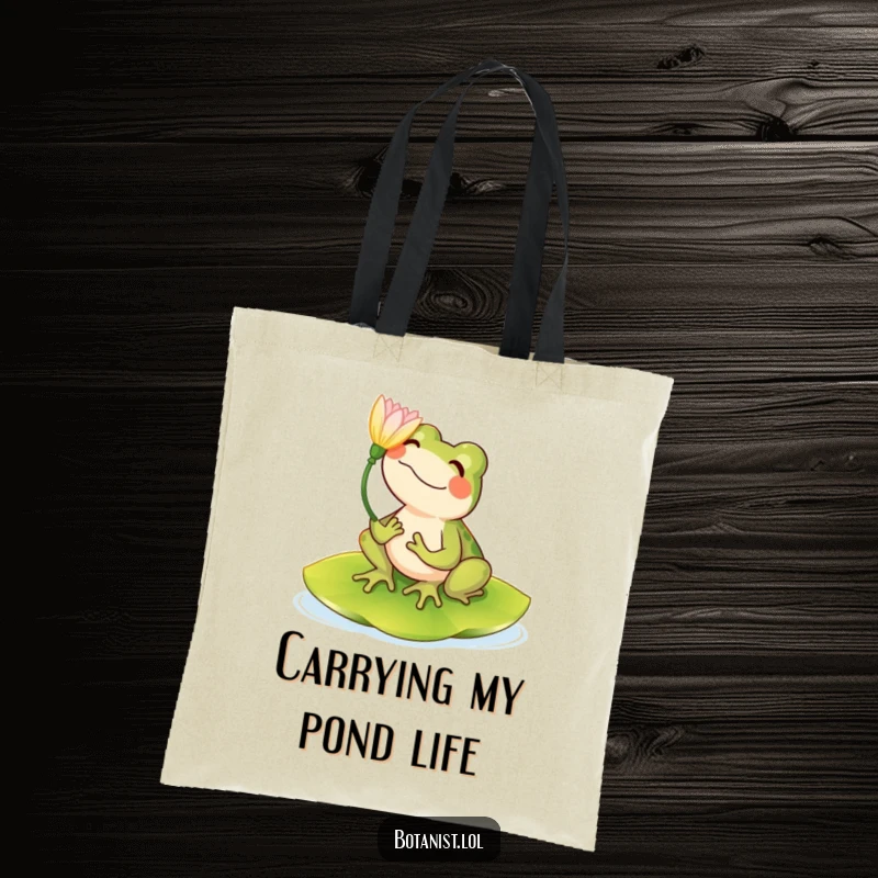 Funny tote bag with a happy frog sitting on a lily pad, admiring a flower, perfect for everyday use.