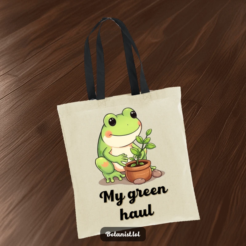 Funny tote bag showing a playful frog carefully tending to a tiny potted sapling, ready for gardening.